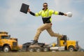 Construction man excited jump with helmet. Builder in helmet outdoor portrait. Worker in hardhat. Construction engineer