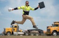 Construction man excited jump with helmet. Builder in helmet outdoor portrait. Worker in hardhat. Construction engineer