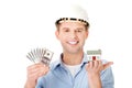 Construction man holding house model and money Royalty Free Stock Photo