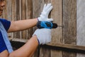 Construction man workers in blue shirt with Protective gloves and working with power drill Royalty Free Stock Photo