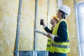 Construction manager and architect checking the insulation works Royalty Free Stock Photo