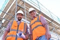 Construction manager and architect on site during the construction of a house - planning and control on site - teamwork Royalty Free Stock Photo