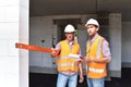 Construction manager and architect on site during the construction of a house - planning and control on site - teamwork Royalty Free Stock Photo