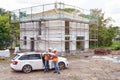 Construction manager and architect on site during the construction of a house - planning and control on site - teamwork Royalty Free Stock Photo