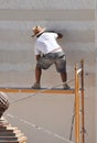 Construction mason renovating the facade of a house
