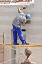 Construction mason renovating the facade of a house