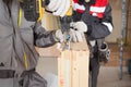 Construction mason worker attach the window metal fitting to skylight.