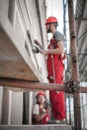 Construction mason worker plastering old building wall using cement plaster mix Royalty Free Stock Photo