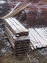 Construction material on building site during snowfall Royalty Free Stock Photo