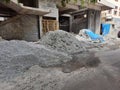 Construction materials like Artificial Sand or crushed sand, small stones, cement heap on roadside during construction of building