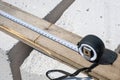 Construction measuring tape. Measuring a wooden board with a tape measure. Length measurement. Royalty Free Stock Photo