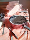 Construction mess, trowel in dried plaster in a bucket, workflow interrupted for a break, out of materials, white coating Royalty Free Stock Photo