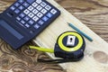 Construction meter-tape measure calculator for calculations pencil and wooden board are on the workbench Royalty Free Stock Photo