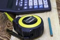 Construction meter-tape measure calculator for calculations pencil and wooden board are on the workbench Royalty Free Stock Photo