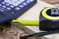 Construction meter-tape measure calculator for calculations pencil and wooden board are on the workbench Royalty Free Stock Photo