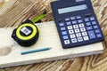 Construction meter-tape measure calculator for calculations pencil and wooden board are on the workbench Royalty Free Stock Photo