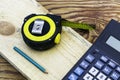 Construction meter-tape measure calculator for calculations pencil and wooden board are on the workbench Royalty Free Stock Photo