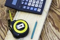 construction meter-tape measure calculator for calculations pencil and wooden board are on the workbench Royalty Free Stock Photo