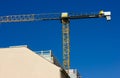 Construction mobile crane against blue sky, apartment building corner under construction. Investment in real estate Royalty Free Stock Photo