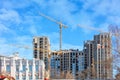 Construction of a modern high-rise residential building against the backdrop of old urban architecture Royalty Free Stock Photo