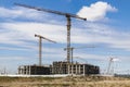 Construction of a monolithic house made of reinforced concrete against the background of a cloudy sky. Tower cranes. Construction Royalty Free Stock Photo