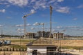 Construction of a monolithic house made of reinforced concrete against the background of a cloudy sky. Tower cranes. Construction Royalty Free Stock Photo