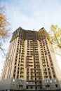 Construction of a multi-storey apartment building in the city. A crane near a skyscraper. Building, moving to a new flat, mortgage Royalty Free Stock Photo