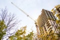 Construction of a multi-storey apartment building in the city. A crane near a skyscraper. Building, moving to a new flat, mortgage Royalty Free Stock Photo
