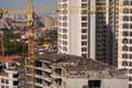 The construction of a multi-storey modern house on the seashore. Installation of floor reinforcement. Tower cranes. September 9, Royalty Free Stock Photo