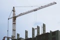 Construction of a multi-storey residential building. Tower crane at a construction site. Construction crane at a construction site Royalty Free Stock Photo