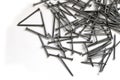 Construction nails, a large amount of nails on a white background Royalty Free Stock Photo