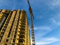 Construction of a new building. a crane transports heavy concrete slabs to build floors. houses without windows, with unusual