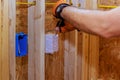 During construction of a new building, an electrician connects wires to socket boxes Royalty Free Stock Photo