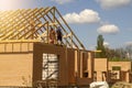 Construction of a new European-style house. Fragment of a new European-style home construction framing against a blue sky.