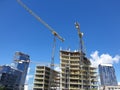 Construction of a new glass high-rise building with crane against a blue sky, Vilnius Royalty Free Stock Photo