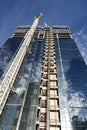 Construction of a new glass and steel skyscraper reflecting the perfect sky Royalty Free Stock Photo