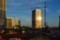 Construction of new high houses. a glare of the sun is visible in the window. cranes stacking blocks to build a new floor. Royalty Free Stock Photo