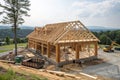 New home construction with wooden truss and post-beam framework Royalty Free Stock Photo