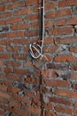 construction of a new house, electrical cables twisted into a knot and fixed to a brick wall close-up, without people Royalty Free Stock Photo