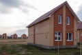 Construction of new model houses of red and yellow bricks. Copy space in the sky. Image for articles on new affordable housing