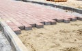 Construction of a new modern sidewalk made of tiles Royalty Free Stock Photo