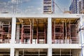 Construction of a new monolithic reinforced concrete house. Scaffolding on the facade of a building under construction. Working at Royalty Free Stock Photo