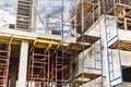 Construction of a new monolithic reinforced concrete house. Scaffolding on the facade of a building under construction. Working at Royalty Free Stock Photo