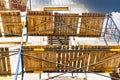 Construction of a new monolithic reinforced concrete house. Scaffolding on the facade of a building under construction. Working at Royalty Free Stock Photo