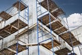 Construction of a new monolithic reinforced concrete house. Scaffolding on the facade of a building under construction. Working at Royalty Free Stock Photo