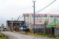 The construction of a new multistory building in the North in the village of Yakutia, Suntar at the end of the wet street