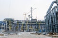 Construction of a new oil refinery, petrochemical plant with the help of large building cranes Royalty Free Stock Photo