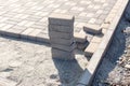 Construction of a new pavement of paving slabs closeup detail. Pavement cobblestone blocks construction of path, road or sidewalk. Royalty Free Stock Photo