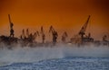 The construction of nuclear icebreakers at magic sunset, cranes of of the Baltic shipyard in a frosty winter day, steam