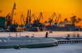 The construction of nuclear icebreakers at magic sunset, cranes of of the Baltic shipyard in a frosty winter day, steam